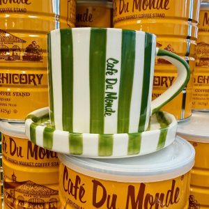 Cafe du Monde Green Cup and Saucer with cans of Coffee and Chicory in the background