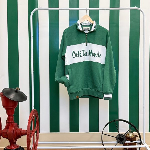 Cafe du Monde Zip Pullover in Green and White hanging up on a dresser